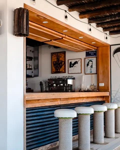 La barra del bar de la terraza, con su cafetera y los taburetes.